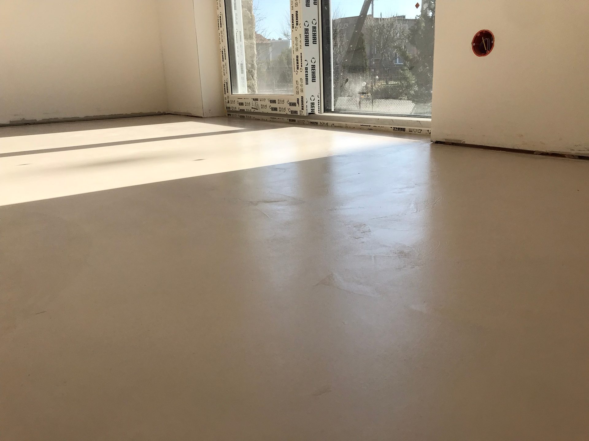 Posadzka z mikrocementu w salonie domu w Rumi